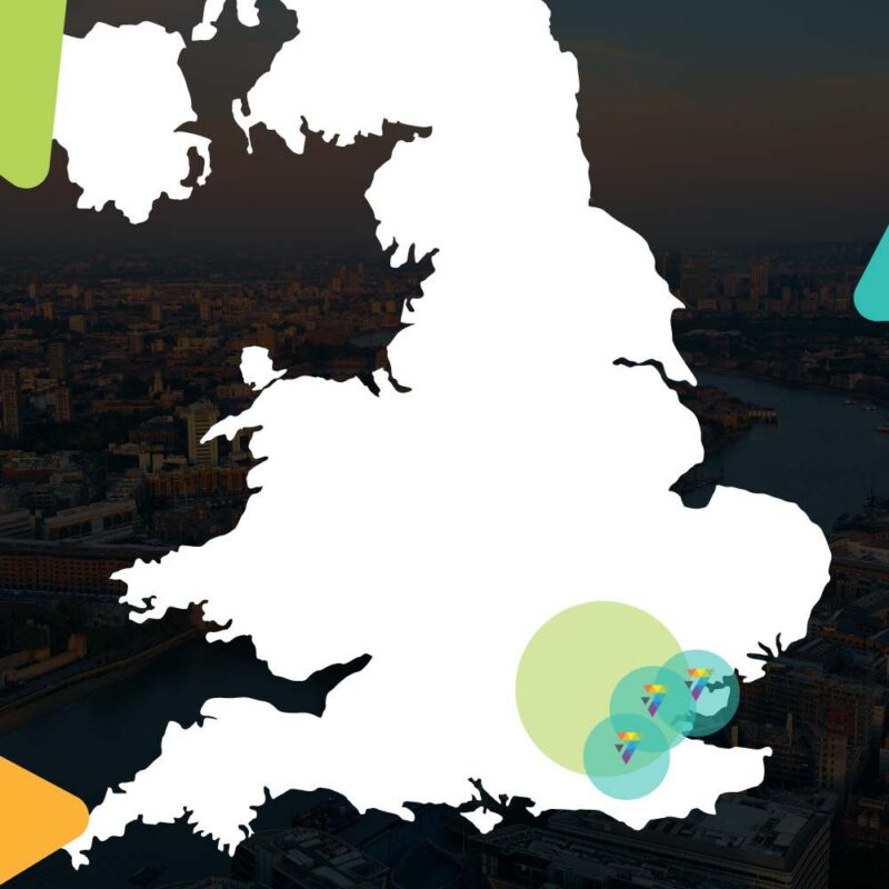 Outline map of England and Wales with colourful Prism7 logo location markers over an aerial London cityscape
